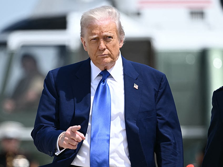 President Donald Trump gestures as he walks to Air Force One at Joint Base Andrews in Mary
