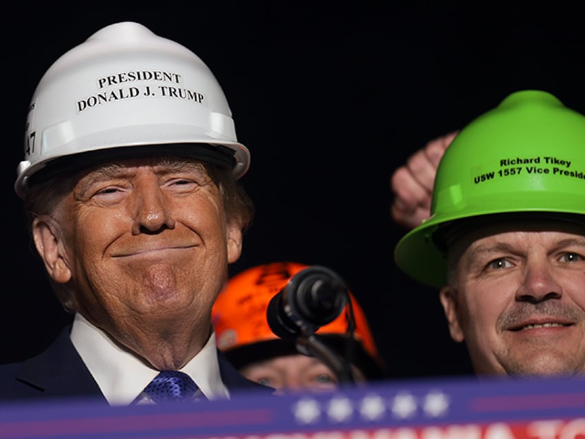 Donald Trump wears a hard hat given to him by steelworkers during a campaign rally on Octo