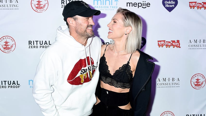 Brian Austin Green and Sharna Burgess posing for a photo