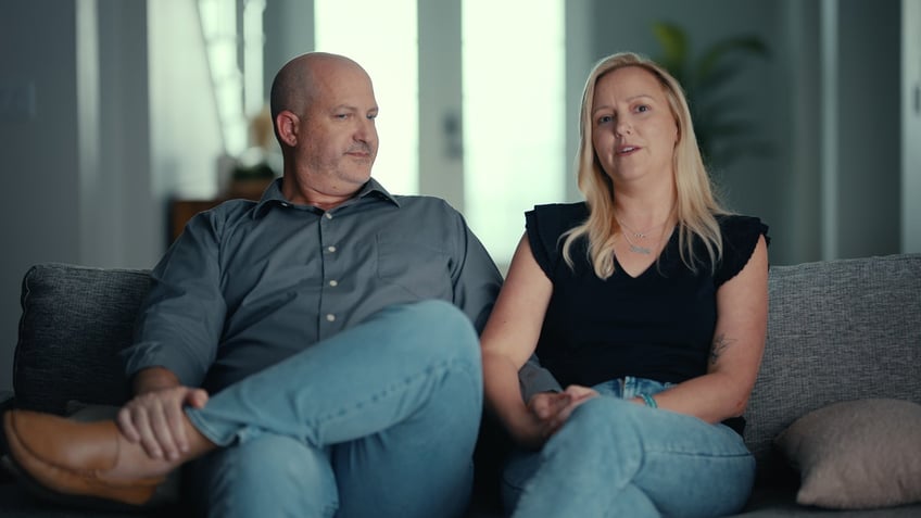 Joseph Petito looks at his wife Tara Petito while sitting on a couch during an interview for Netflix's "American Murder: Gabby Petito"