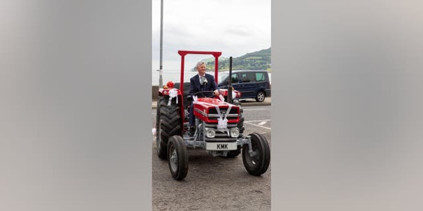 bridal haul woman arrives for her wedding on the back of a tractor laughed the whole way