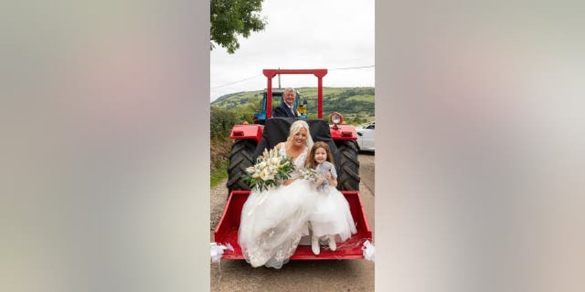 bridal haul woman arrives for her wedding on the back of a tractor laughed the whole way