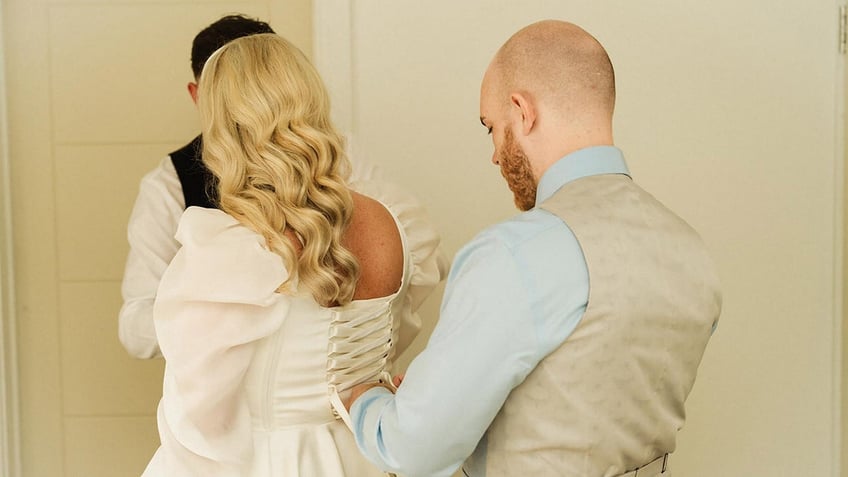 Bride with brother in wedding dress