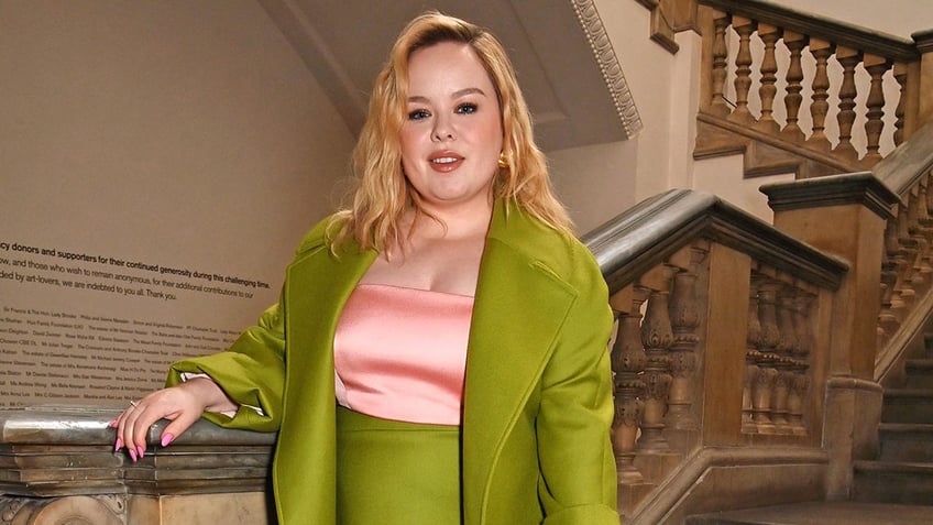 Nicola Coughlan standing on a staircase