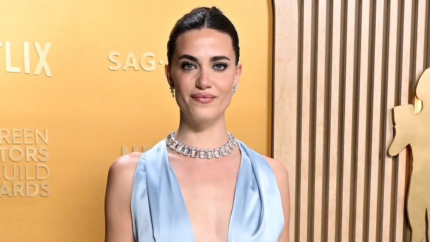 Genevieve Chenneour on the red carpet wearing a silk, baby blue dress.