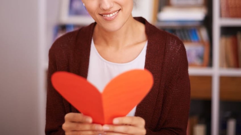 A woman reads a Valentine's Day card