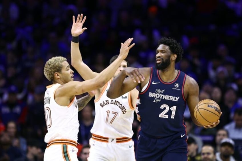 Philadelphia 76ers Joel Embiid shields the basketball from San Antonio on his way to a dazzling 70-point performance