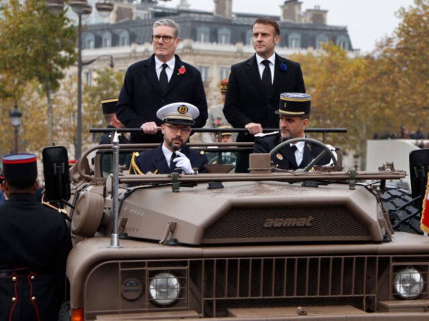 TOPSHOT - France's President Emmanuel Macron (R) and Britain's Prime Minister Ke