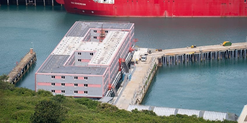 britain removes migrants from barge after finding dangerous bacteria in water system