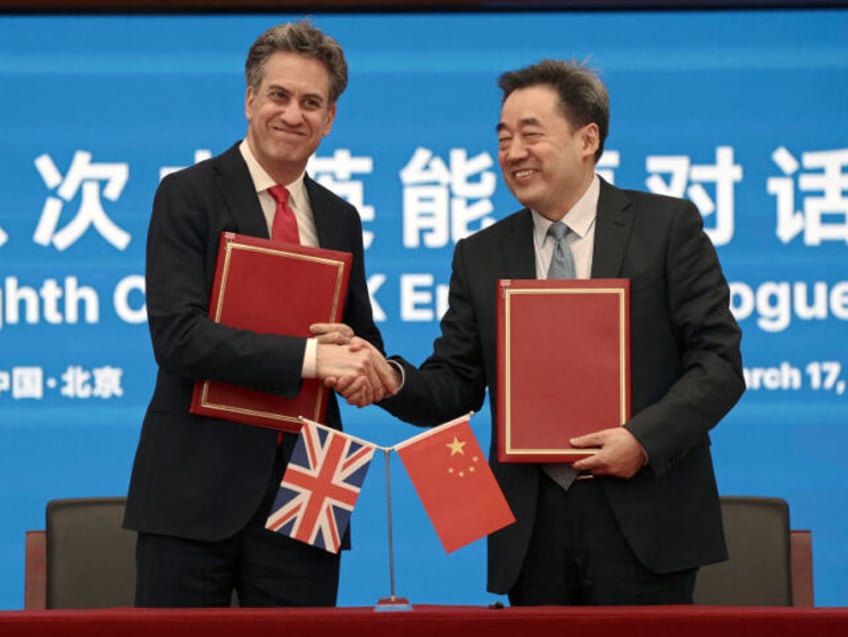 Britain's Energy Secretary Ed Miliband (L) and Wang Hongzhi, head of China's Nat