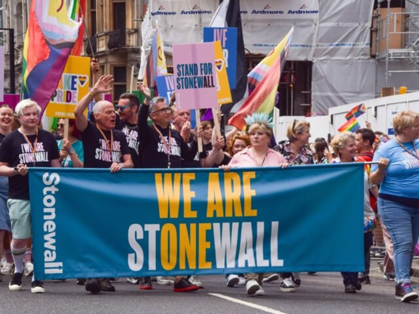 LONDON, UNITED KINGDOM - 2023/07/01: Participants hold a 'We are Stonewall' banner during