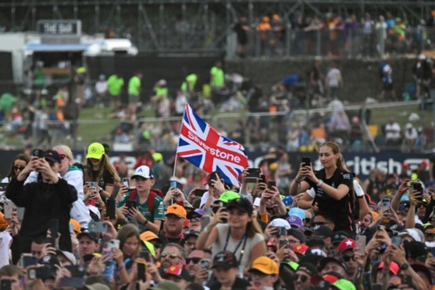 F1 fans watch the podium ceremony for the British Grand Prix at Silverstone