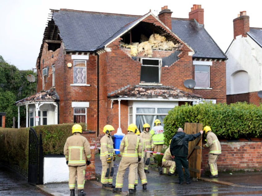 Firemen secure a house that was damaged by the winds of storm Eowyn that hit the country i