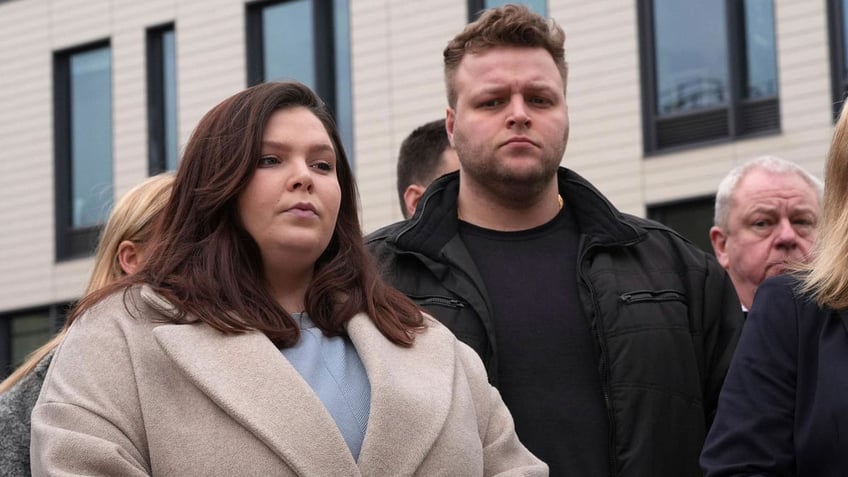 Ellie and Harry Baxter, the son and daughter of Stephen, 61, and Carol, 64, Baxter, stand outside Chelmsford Crown Court