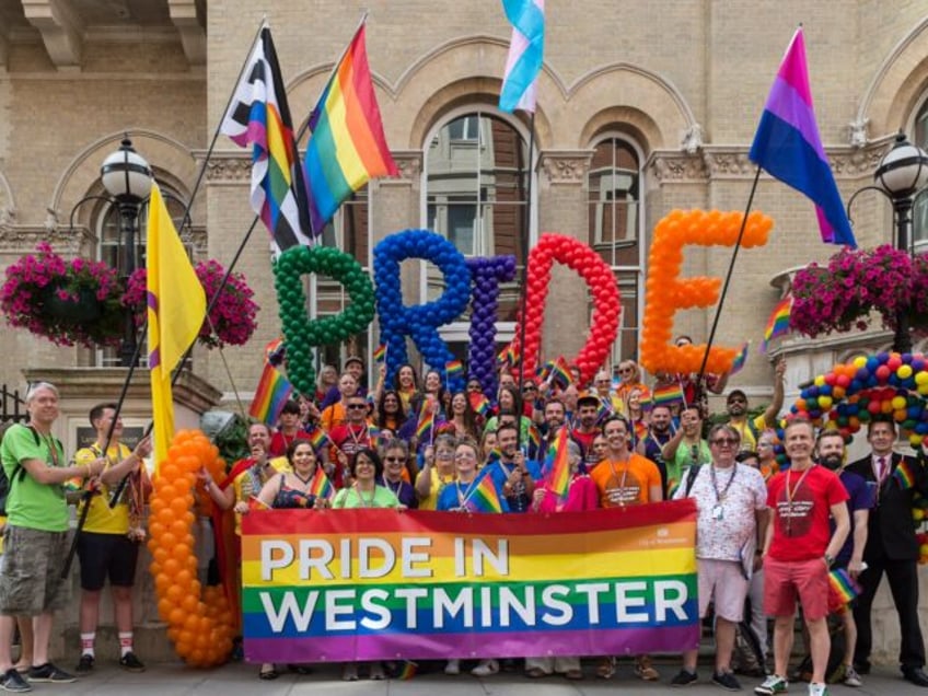 Participants gather for the Pride in London parade on 06 July, 2019 in London, England. Th