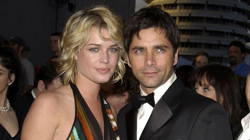 Rebecca Romijn walks red carpet with John Stamos in a tux