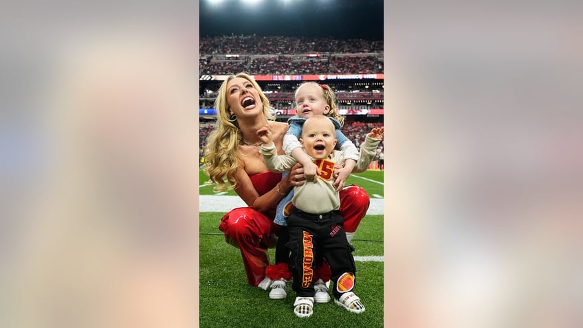 Brittany Mahomes poses for a photo with her children Sterling and Bronze