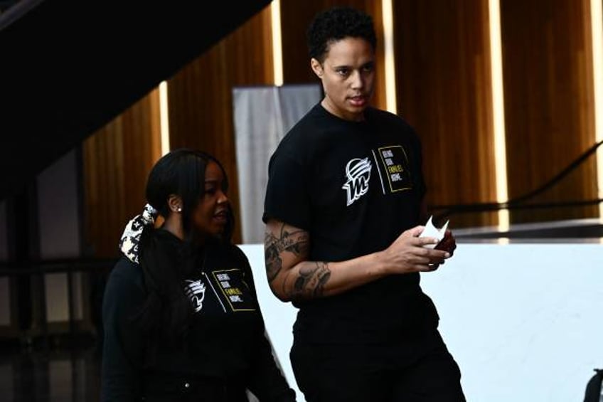 Basketball player Brittney Griner , of the Phoenix Mercury, and her wife Cherelle Griner arrive at a news conference at the Footprint Center in...