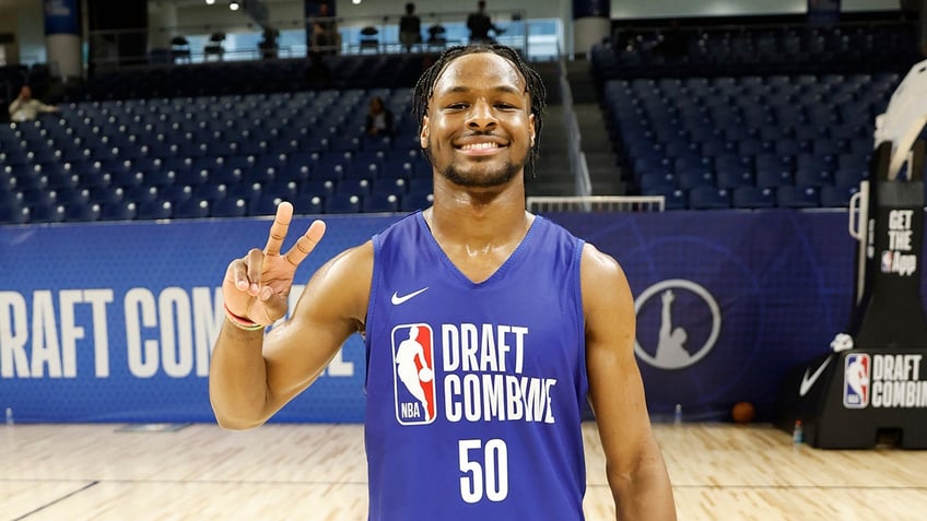 Bronny James throws up peace sign