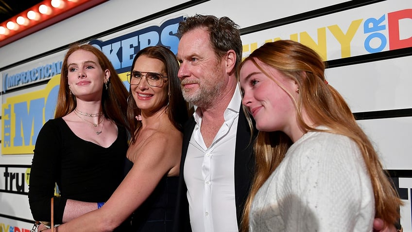 Brooke Shields, Chris Henchy pose with their two daughters at an event