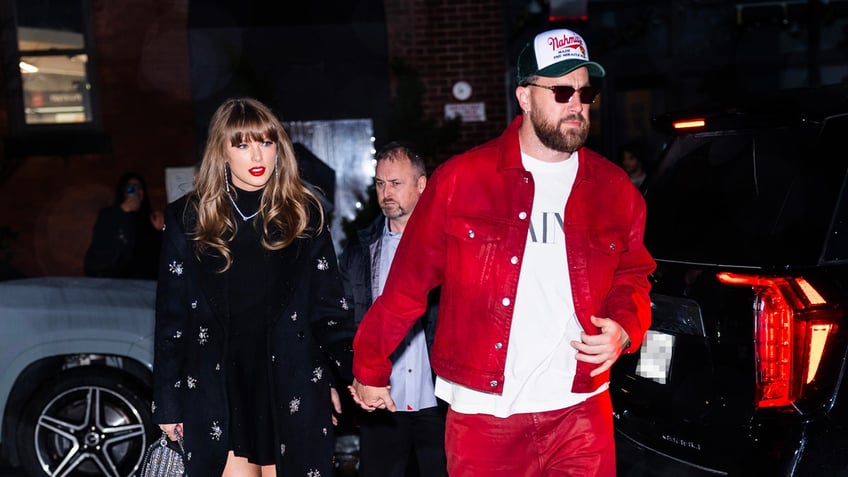 Taylor Swift and Travis Kelce hold hands