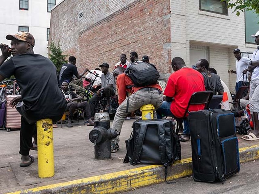 Men gather outside of two shelters in Brooklyn housing recently arrived migrant men on Jul