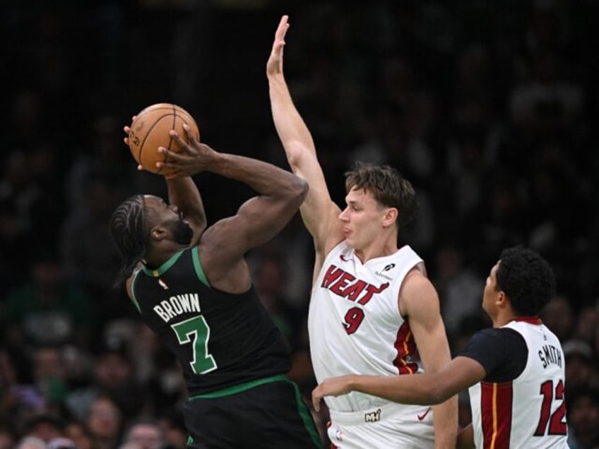 Jaylen Brown attempts to shoot over Pelle Larsson and Dru Smith during the Boston Celtics'