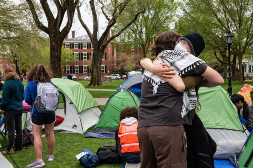 Pro-Palestinian students embrace each other as they take down their encampment after reach