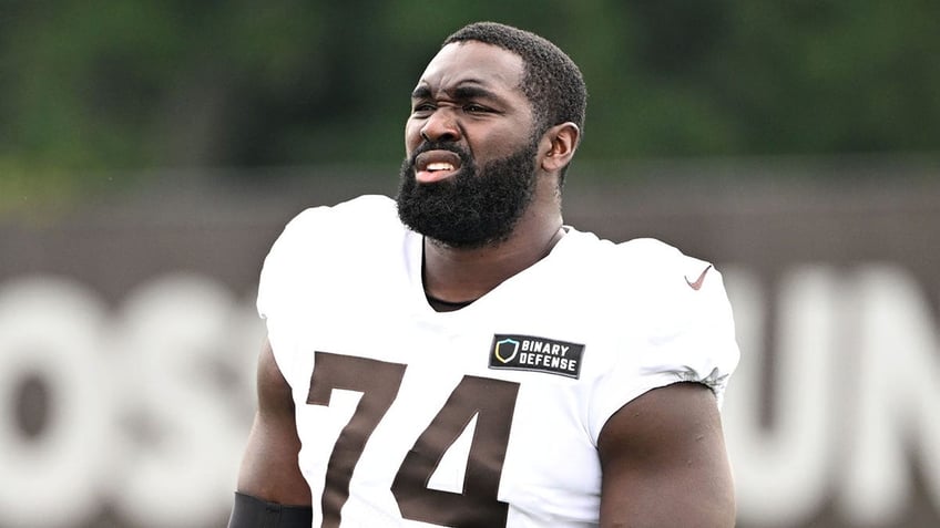 Hakeem Adeniji looks on practice field