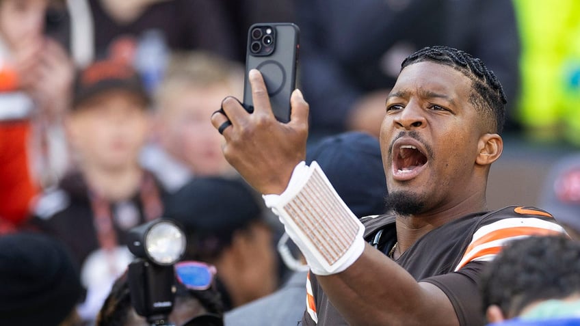 Oct 27, 2024; Cleveland, Ohio, USA; Cleveland Browns quarterback Jameis Winston (5) takes a selfie after defeating the Baltimore Ravens at Huntington Bank Field. Mandatory Credit: Scott Galvin-Imagn Images