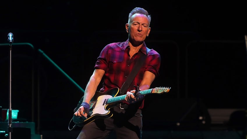 Bruce Springsteen playing guitar on stage