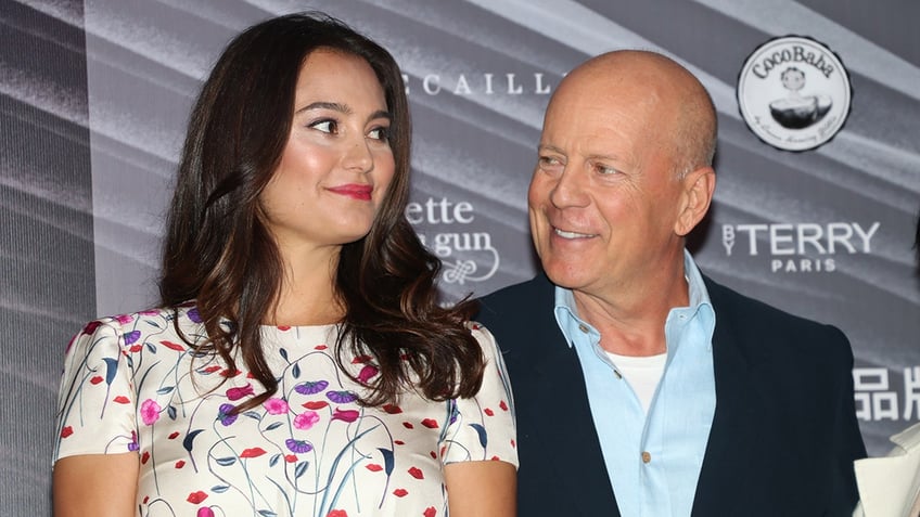Bruce Willis smiling at his wife, model Emma Heming.