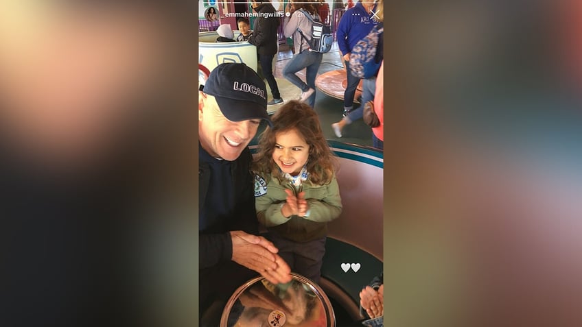 Willis and his daughter riding the teacups ride at Disneyland.