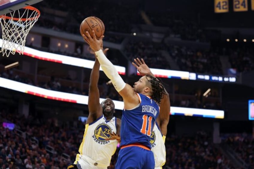 New York Knicks talisman Jalen Brunson soars over Golden State's Draymond Green on his way