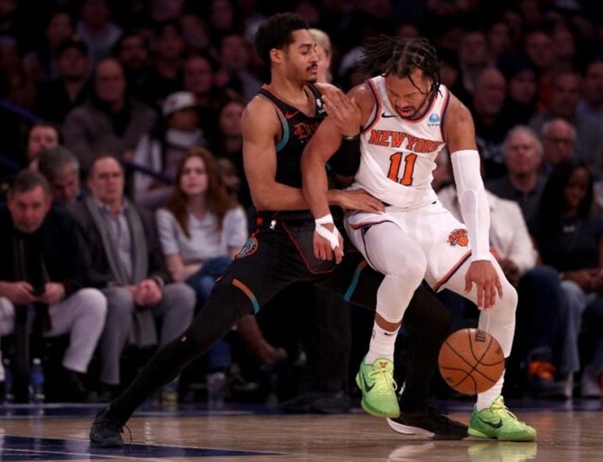 Jordan Poole of the Washington Wizards and Jalen Brunson of the New York Knicks fight for position in the Knicks' NBA victory over the Wizards