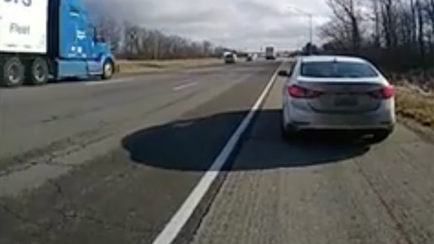 White car pulled over on side of highway