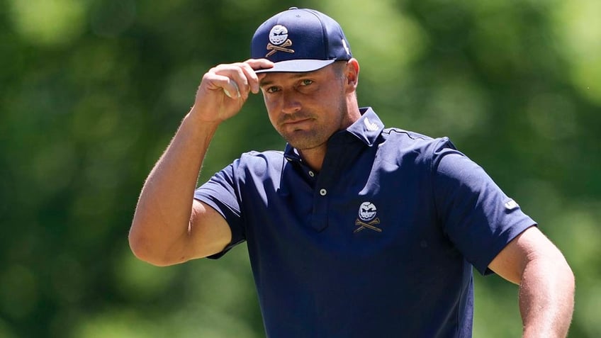 Bryson DeChambeau tips his cap