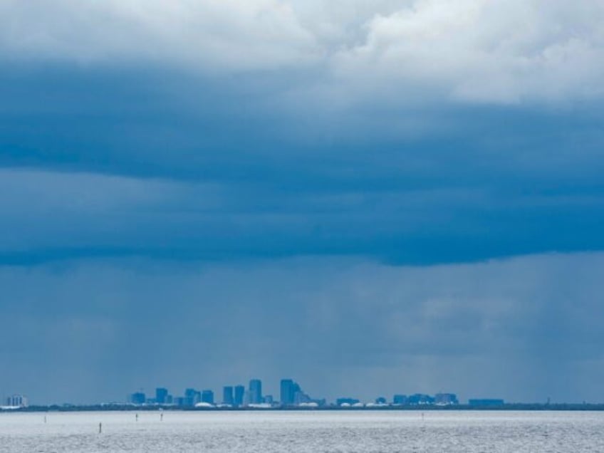 A thunderstorm can be seen moving over Tampa in the distance from St. Petersburg, Florida