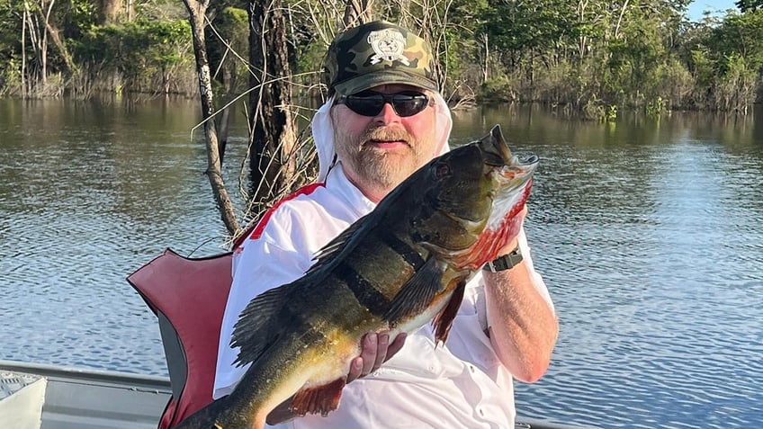 Buck McNeely holds a fish