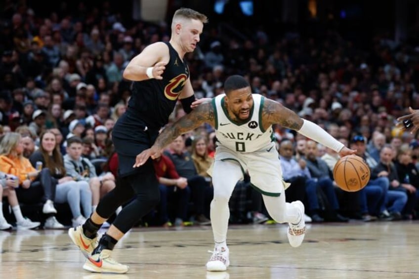 Damian Lillard of the Milwaukee Bucks drives on Sam Merrill of the Cleveland Cavaliers during Friday's game which ended in a 119-11 win for the Bucks.