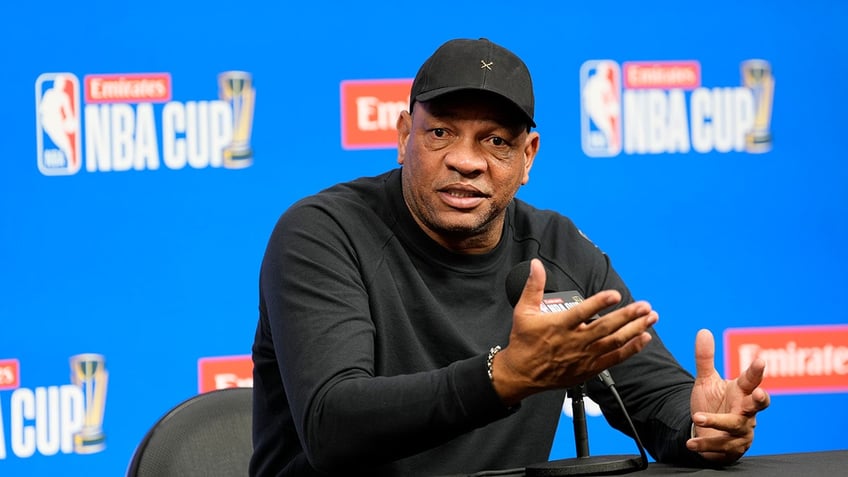 Doc Rivers talks at desk