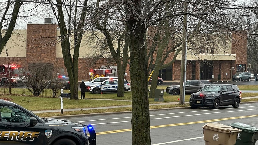 Emergency vehicles are parked outside the Abundant Life Christian School i