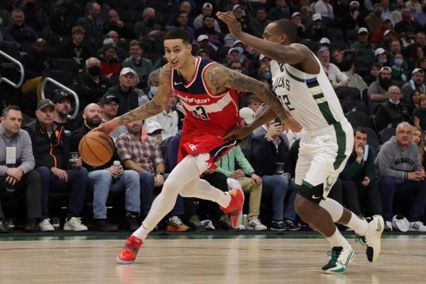 Washington's Kyle Kuzma, left, and Milwaukee's Khris Middleton, right, have reportedly swa