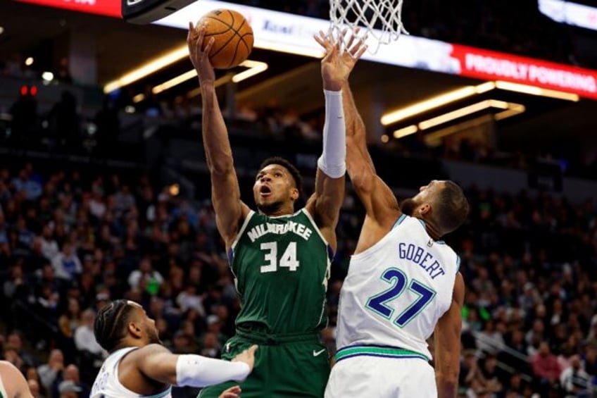 Giannis Antetokounmpo of the Milwaukee Bucks rises for a shot against Minnesota's Rudy Gob