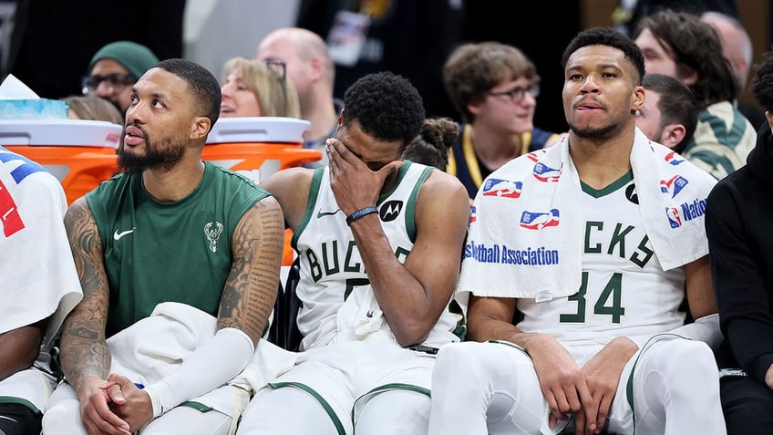 Milwaukee Bucks players sit on the bench