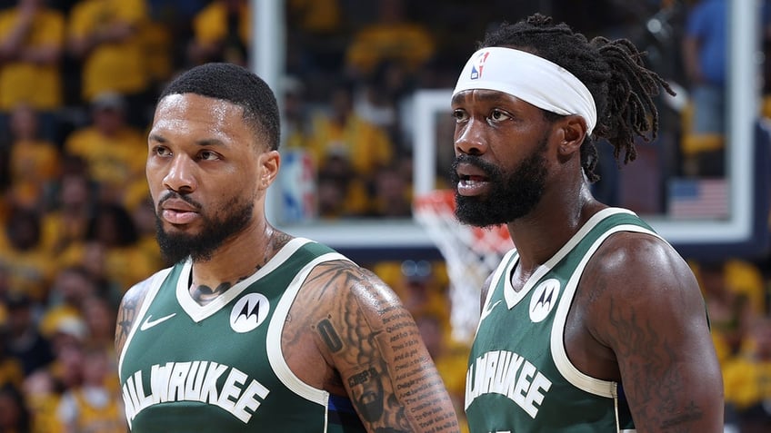 Damian Lillard and Patrick Beverley look on