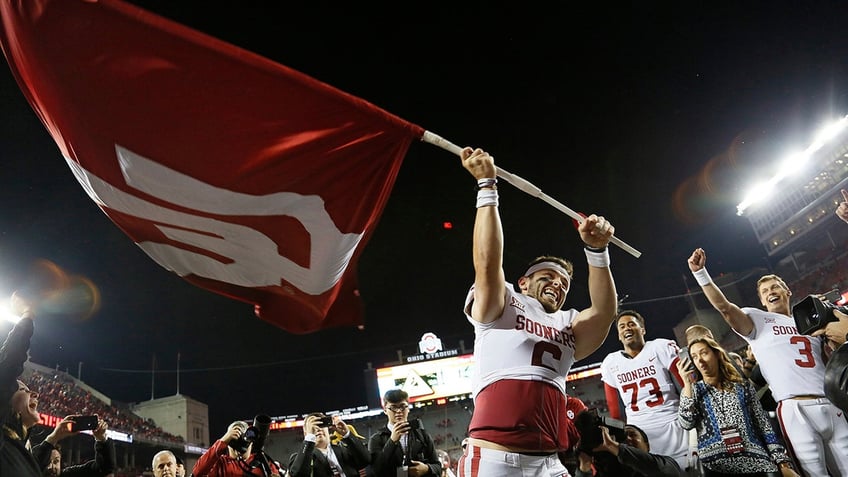 Baker Mayfield waves the OU flag