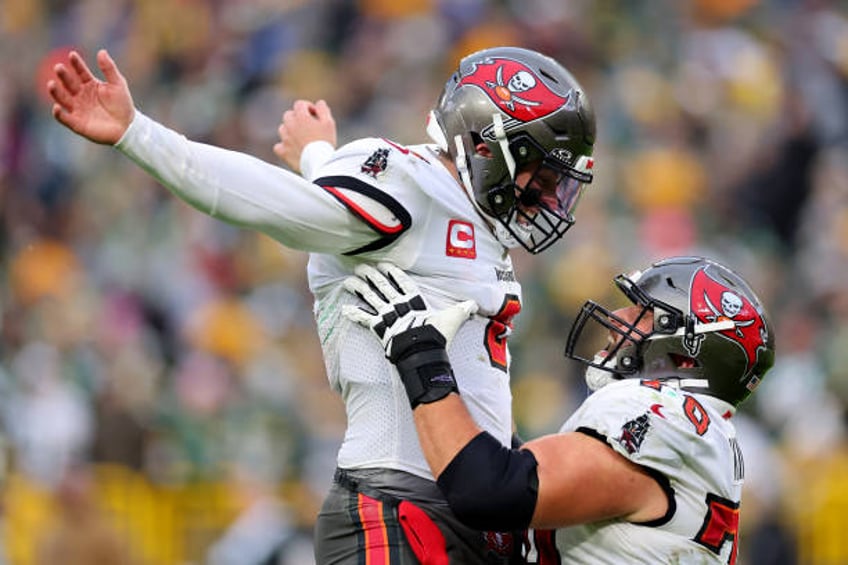 Baker Mayfield and Robert Hainsey both of the Tampa Bay Buccaneers celebrate after Mayfield's touchdown pass during the fourth quarter against the...