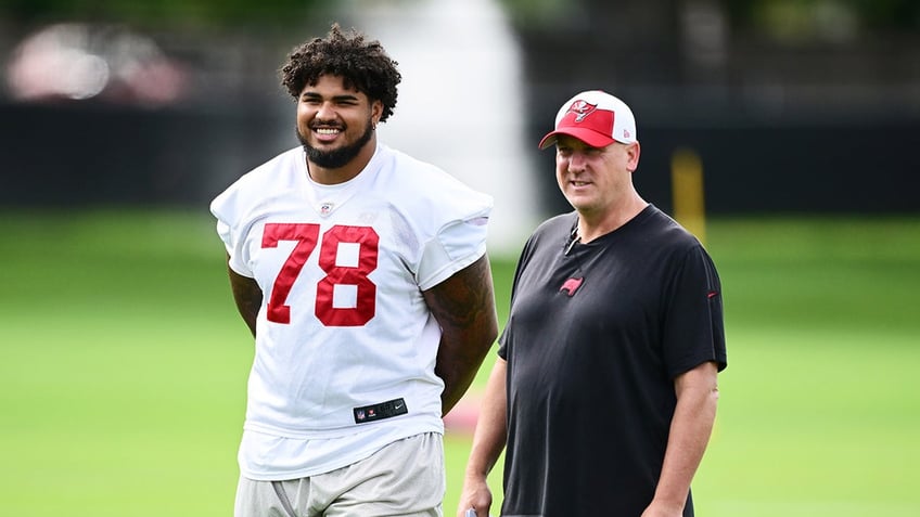 Tristin Wirfs looks on at practice