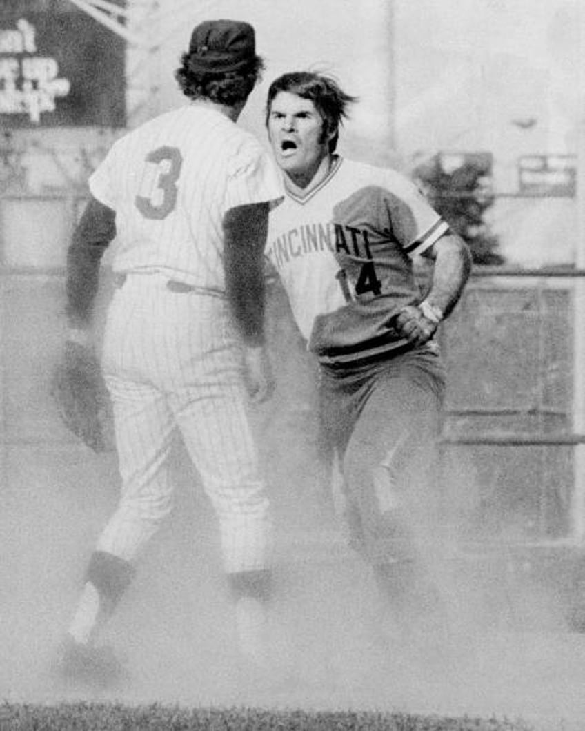 Pete Rose of the Cincinnati Reds starts fight with Bud Harrelson of the New York Mets during a National League playoff game at Shea Stadium.